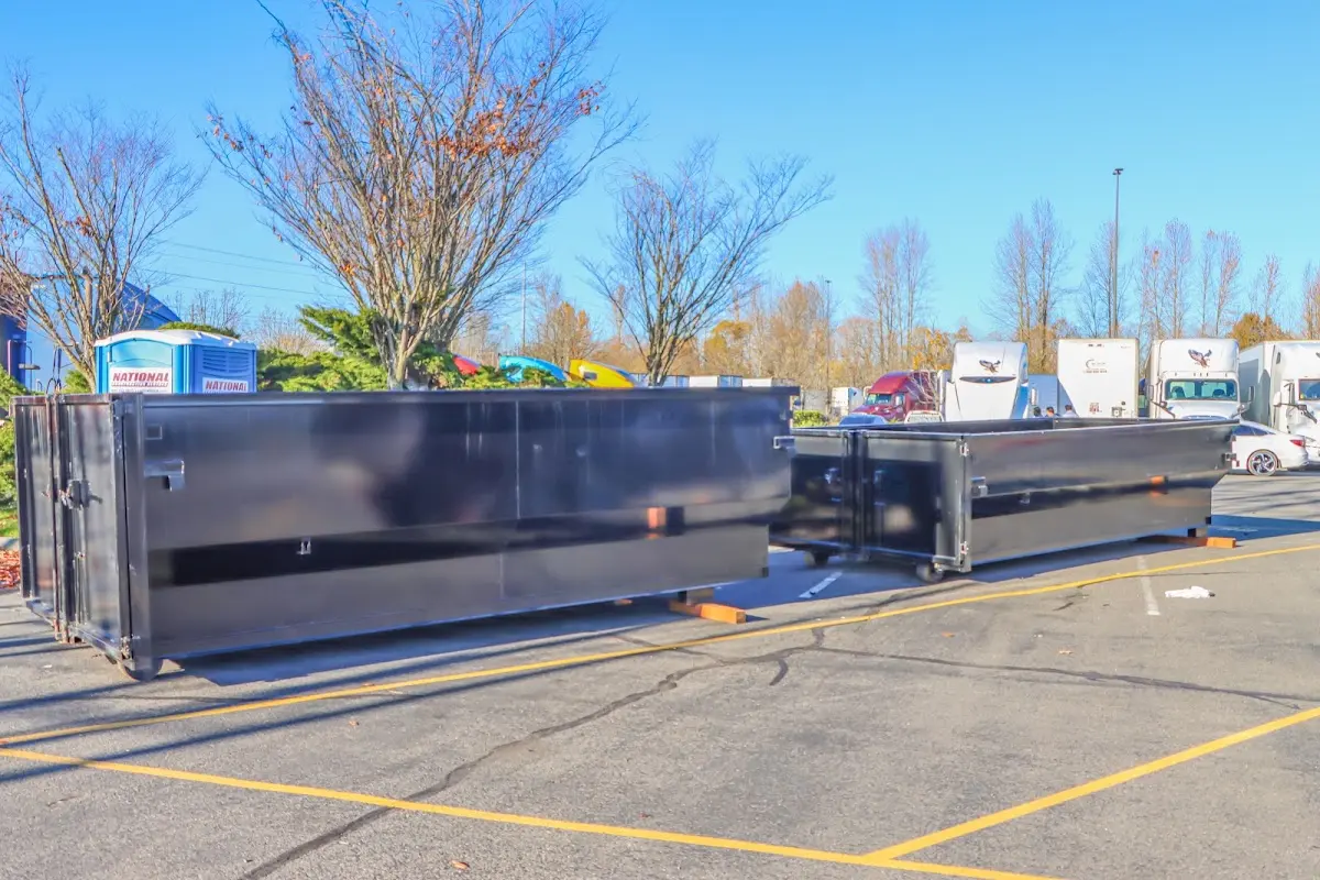 Professional dumpster rental service with roll-off container on residential driveway in McNair